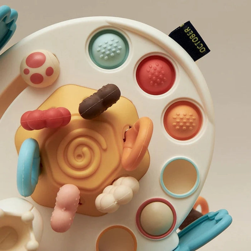 Ufo Bloom – Klassiek babyspeelgoed in de vorm van een UFO met trekkoorden en voelbare zijknoppen