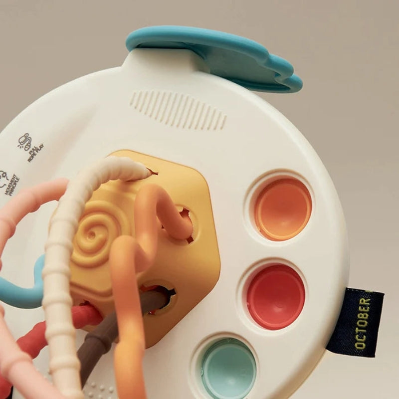 Ufo Bloom – Klassiek babyspeelgoed in de vorm van een UFO met trekkoorden en voelbare zijknoppen