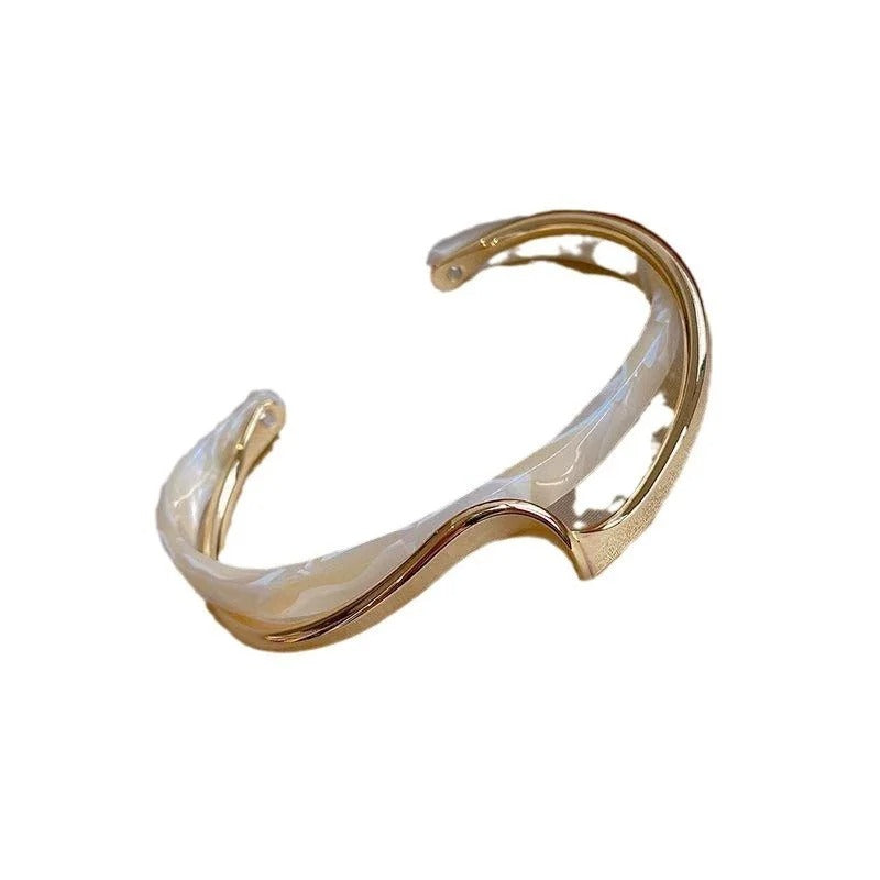 Clara – Pulsera geométrica abierta con silueta curva y un acabado moderno y elegante
